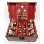 A Georgian oak decanter box with red fitted suede interior holding six large decanters, six small