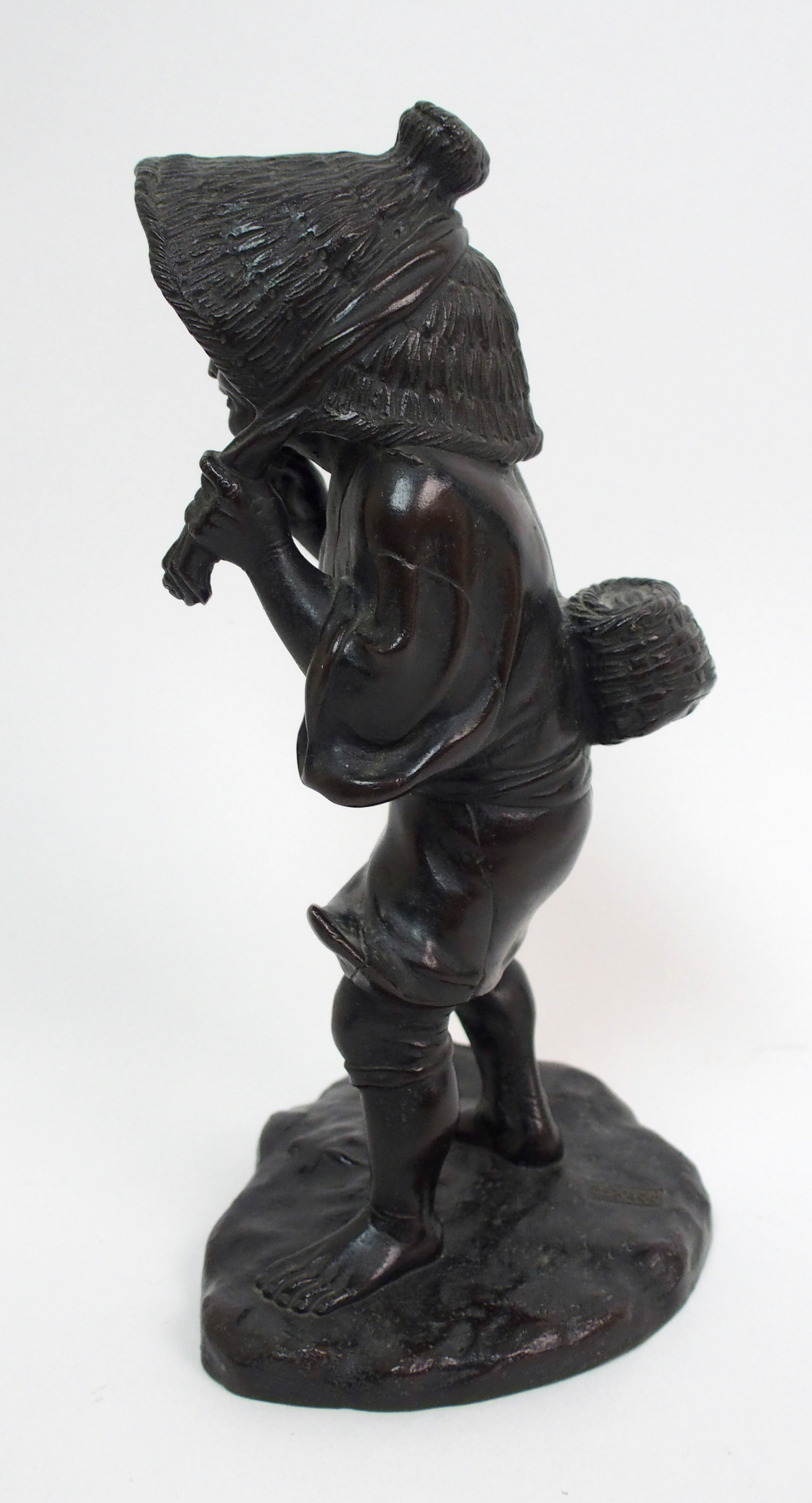 A Japanese bronze figure of a worker standing and holding straw hat around her head and on a mound - Image 7 of 8