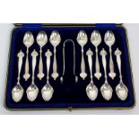 A set of twelve Art Nouveau silver coffee spoons and tongs by Lee & Wigfull, Sheffield 1905, the