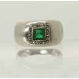 A white metal emerald and diamond ring of domed form, diamonds rose cut and square cut emerald (af).