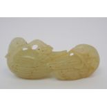 A Chinese jade carving of two ducks each with lily branches in mouths, 6.7cm wide