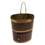 A Georgian mahogany and brass bound plate bucket with swing handle, lift-out drawer above a base