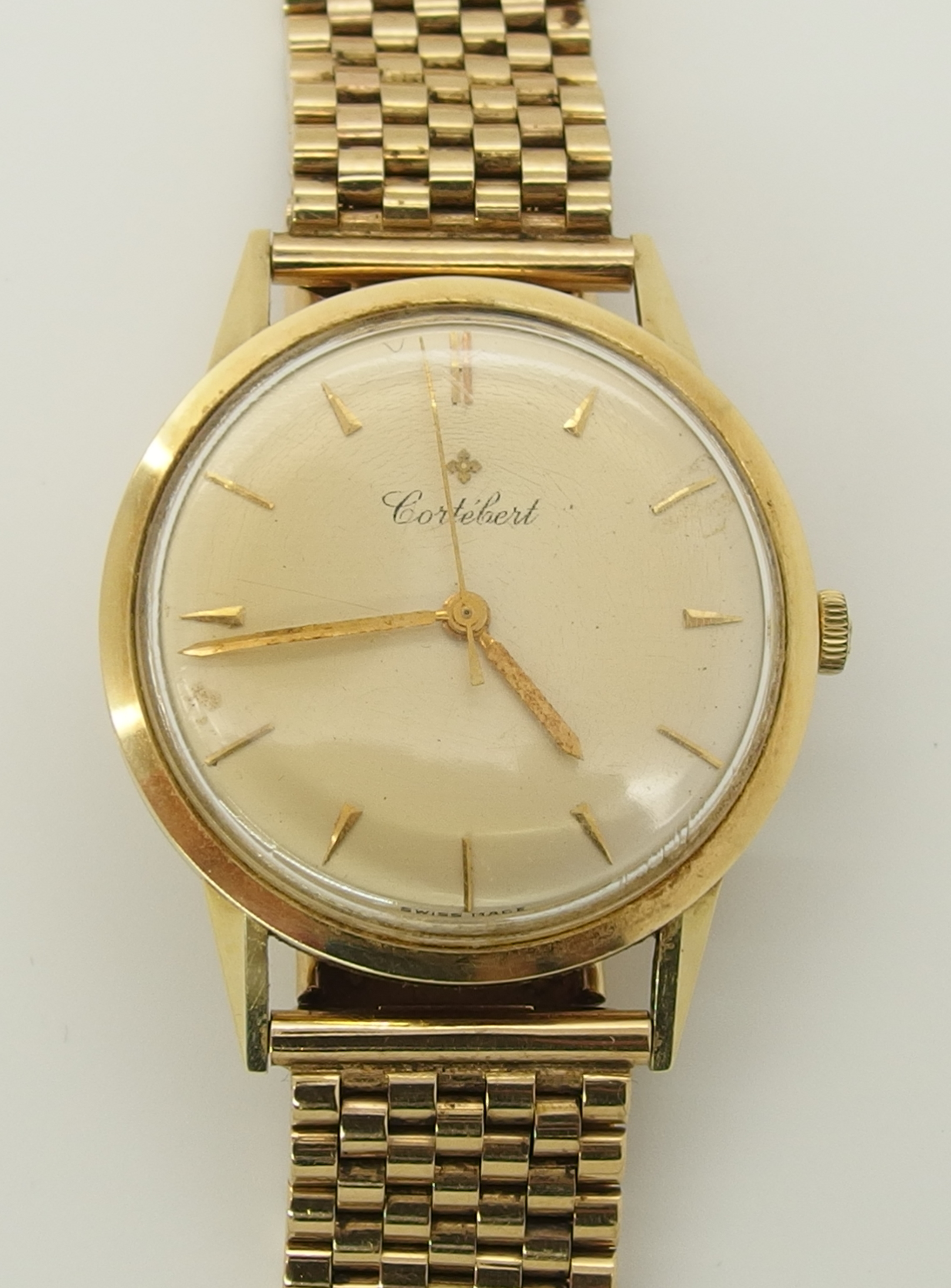 A 14ct gold Cortebert gents watch with a 9ct gold strap, the champagne dial has gold coloured