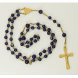 An 18ct yellow gold and lapis lazuli rosary stamped 750 to the crucifix, the quality lapis lazuli