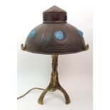 A continental gilded metal table lamp the shade with opalescent and ruby glass nuggets within wavy