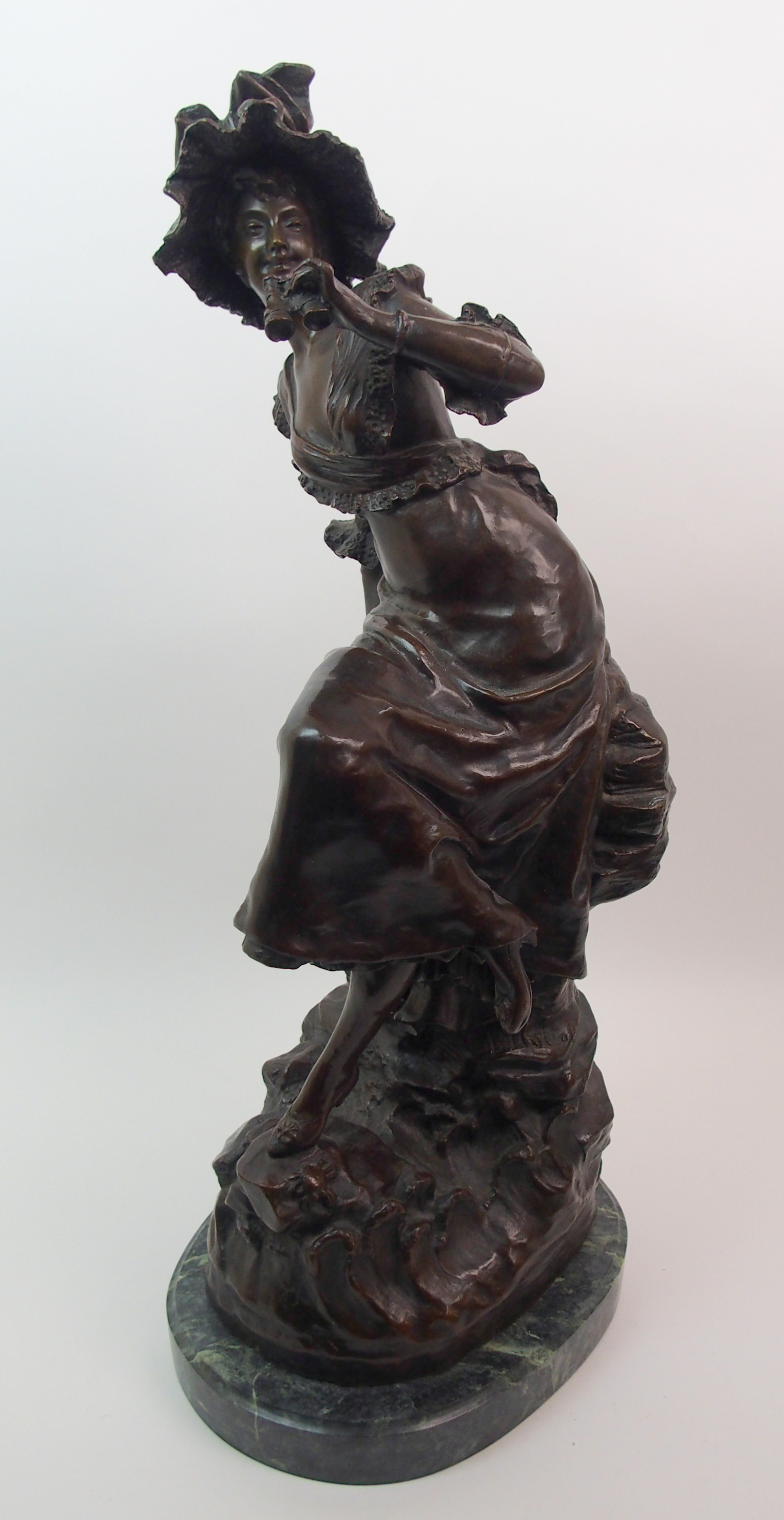 After Louis Ernst Hottot (French, 1834-1905) A bronze of a girl with binoculars modelled as a girl