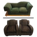 An Art Deco three piece suite comprising; a green upholstered sofa with a walnut frame and side