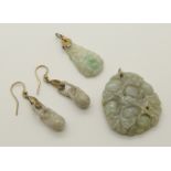200A collection of Chinese green hardstone jewellery comprising a double sided pendant carved with a