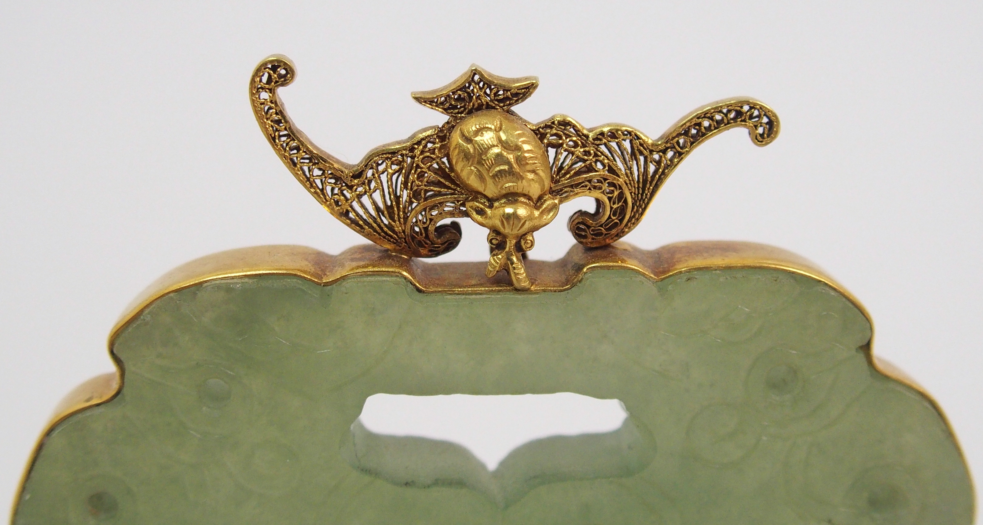 A Chinese hardstone pendant disc carving with conjoined grotesques, set within a gilt metal - Image 3 of 10