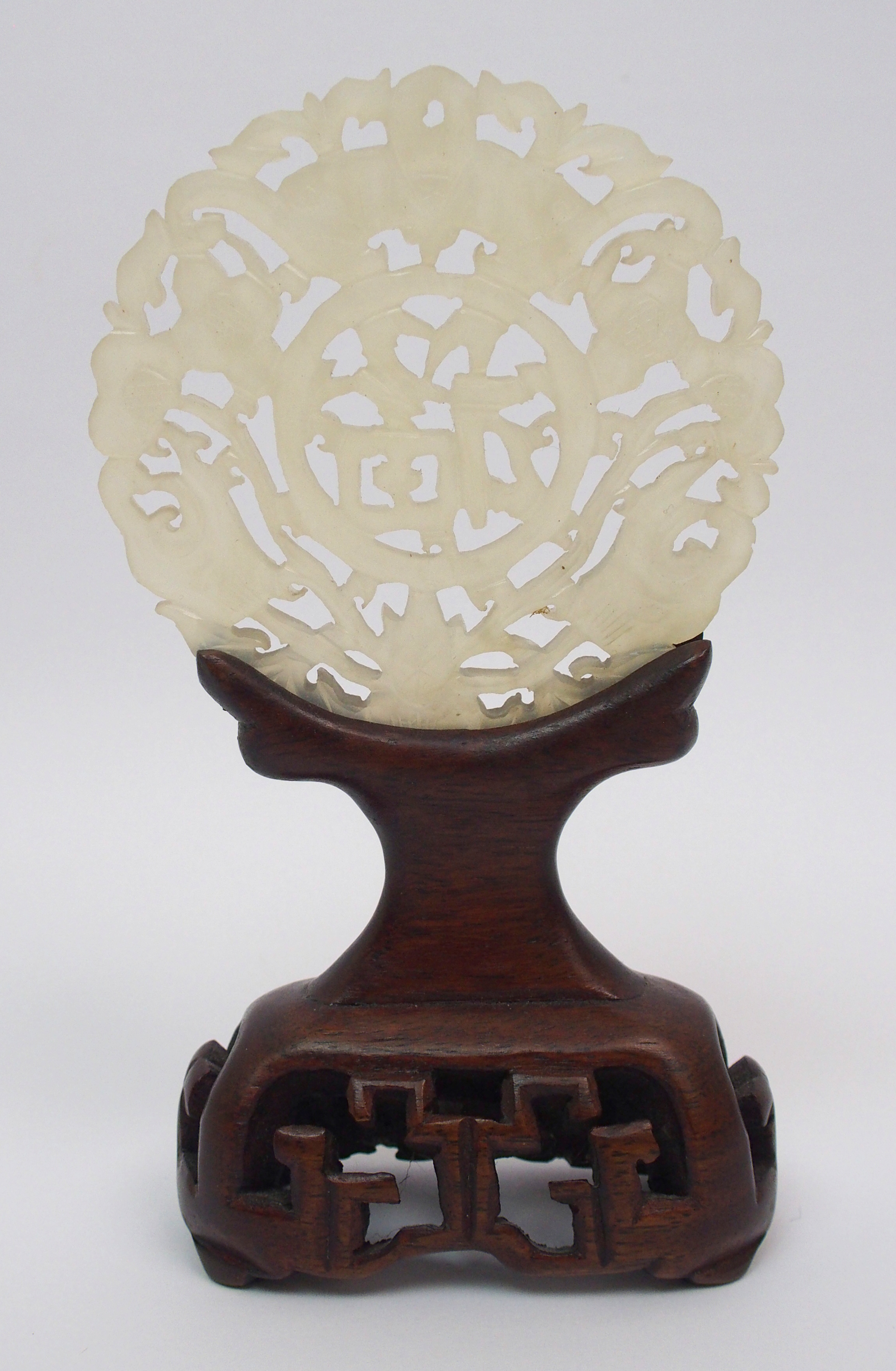 A Chinese hardstone medallion carved with bats surrounding characters, 7cm diameter, wood stand - Image 3 of 10