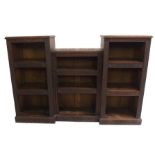 A Victorian oak and pine carved pedestal bookcase with nine shelves surrounded by foliate and