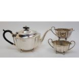 A silver three piece tea set by Fenton Brothers Ltd, Sheffield, 1931, on ball feet, approximately