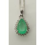 A 9ct white gold emerald and diamond pendant dimensions 2.2cm x 1.1cm, with a silver chain, length
