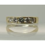 An 18ct gold five stone diamond ring channel set to the band, the five diamonds have an estimated