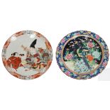 An Arita charger painted with an archer and servant, within a foliate border, 45.5cm diameter and