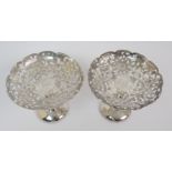 A pair of Chinese white metal bonbon dishes pierced and decorated with peonies surrounding a