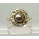 An 18ct gold black pearl and diamond ring the pearl is approx 6.25mm and surrounded with old cut