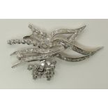 An 18ct white gold diamond spray brooch of abstract floral form, estimated approx diamond content