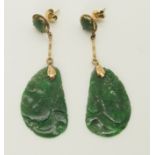 A pair of 14ct gold and Chinese green hardstone earrings the hardstone plaques are carved with birds