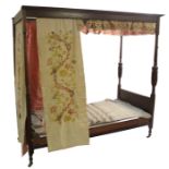 An oak baronial style four poster single bed with baluster turned columns and panelled boards,