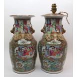 A pair of Canton famille rose vases painted with panels of figures on pavilions within key pattern