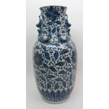 A Chinese blue and white baluster vase painted with flower heads and scrolling foliage, beneath