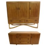 A light Ercol sideboard on a cross stand with three cupboard doors over two drawers, 114cm x 130cm x