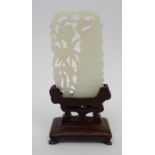 A Chinese jade carving pierced with bamboo and flowering foliage, 6cm high, wood stand