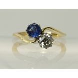An 18ct gold diamond and sapphire twin stone on a twist ring diamond of estimated approx 0.50cts.