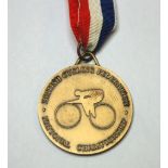 A yellow-metal British National Championship gold medal the obverse inscribed British Cycling