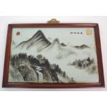 A Chinese rectangular tile picture painted with pagodas in a mountainous landscape, within