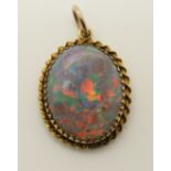 A boulder opal pendant in a 9ct mount cut and polished to maximise size, so not perfectly domed,