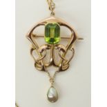 A 15ct rose gold Art Nouveau pendant set with a peridot and a blister pearl the peridot is emerald