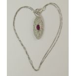 An 18ct white gold ruby and diamond pendant of pave pierced out design with a fine chain, length