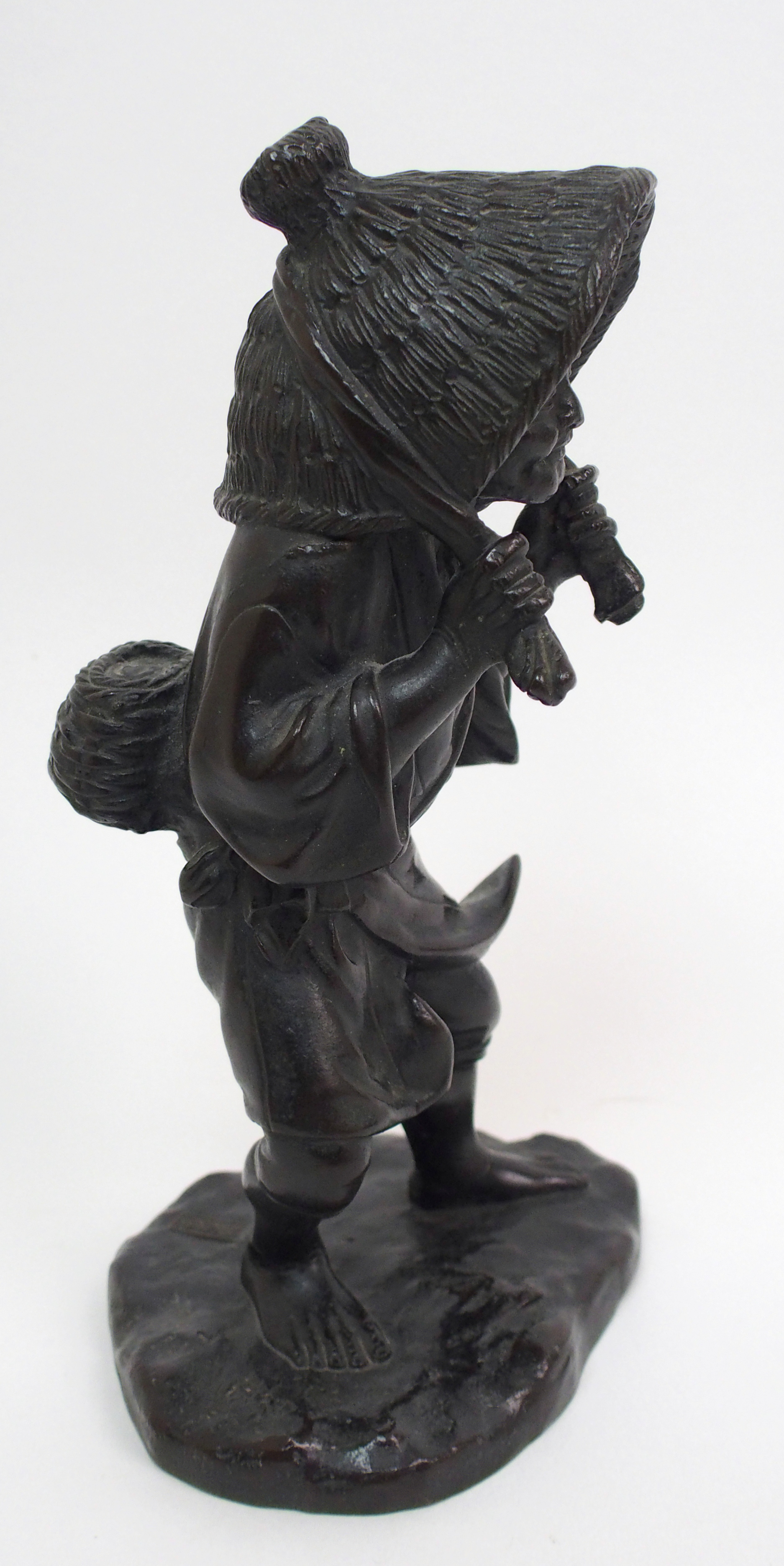 A Japanese bronze figure of a worker standing and holding straw hat around her head and on a mound - Image 4 of 8