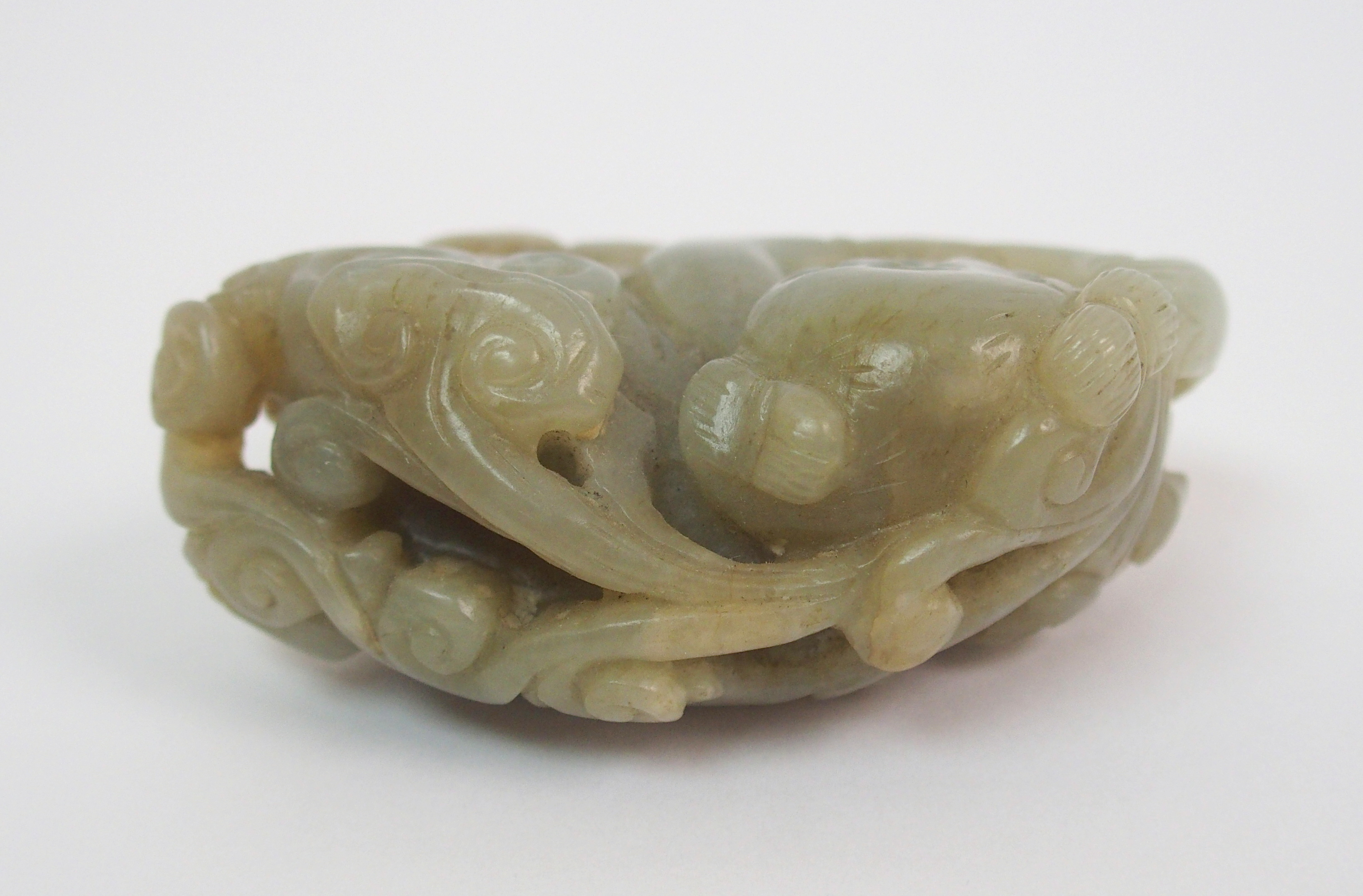 A Chinese jade carving of a child lying and holding lingzhi frond, 7cm wide - Image 5 of 10