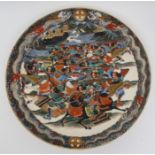 A Satsuma charger painted with warriors in conflict before a river city and within a border of