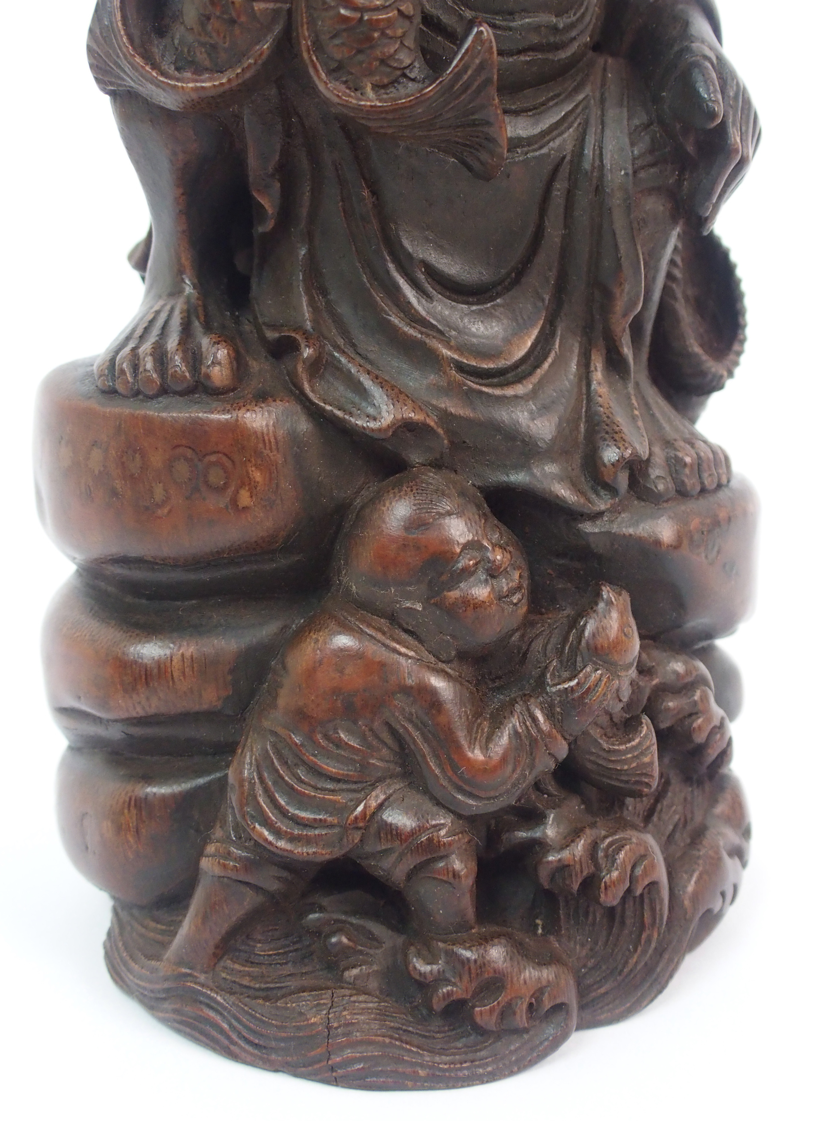 A Chinese bamboo figure of a fisherman seated on a rock above a young boy holding a fish amongst - Image 3 of 10