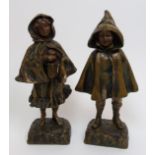 Tremo - A pair of bronze figures modelled as a boy and a girl in cloaks, both with green and brown