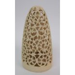 An Indian ivory Buddha standing within a foliate scrolling frame, 12cm high, wood stand