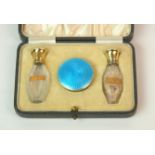 A cased silver and enamel pair of scent bottles with matching pill box by Martin Hall & Co Ltd,