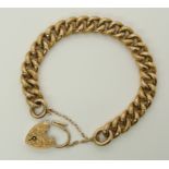 A 15ct gold curb chain bracelet with an engraved heart shaped clasp, hallmarked 15ct to every link
