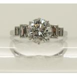 A platinum and diamond Art Deco ring the central diamond of estimated approx 1.24cts with four