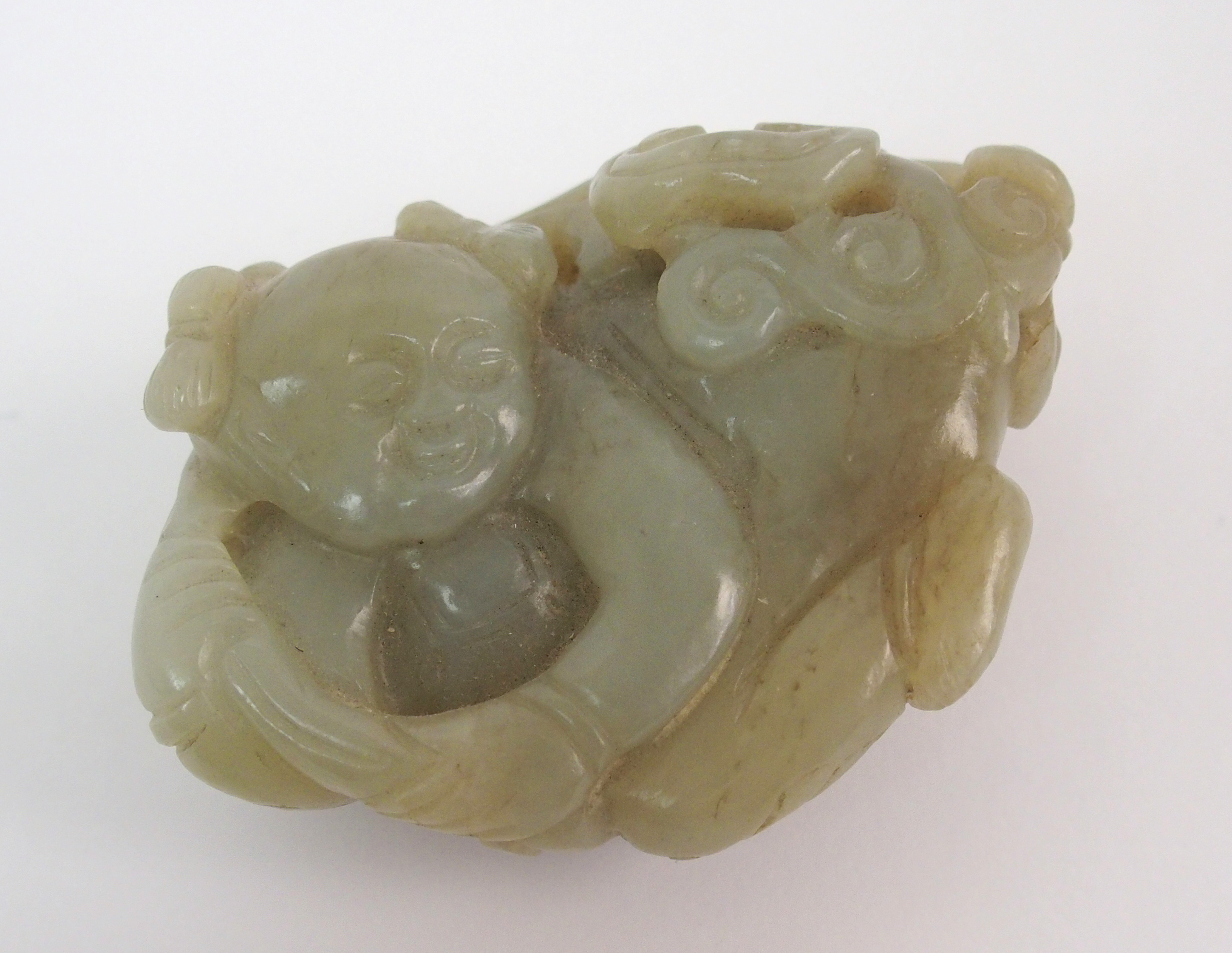 A Chinese jade carving of a child lying and holding lingzhi frond, 7cm wide - Image 10 of 10