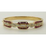 An 18ct gold ruby and diamond bangle estimated approx diamond content 1.40cts, internal diameter 4.