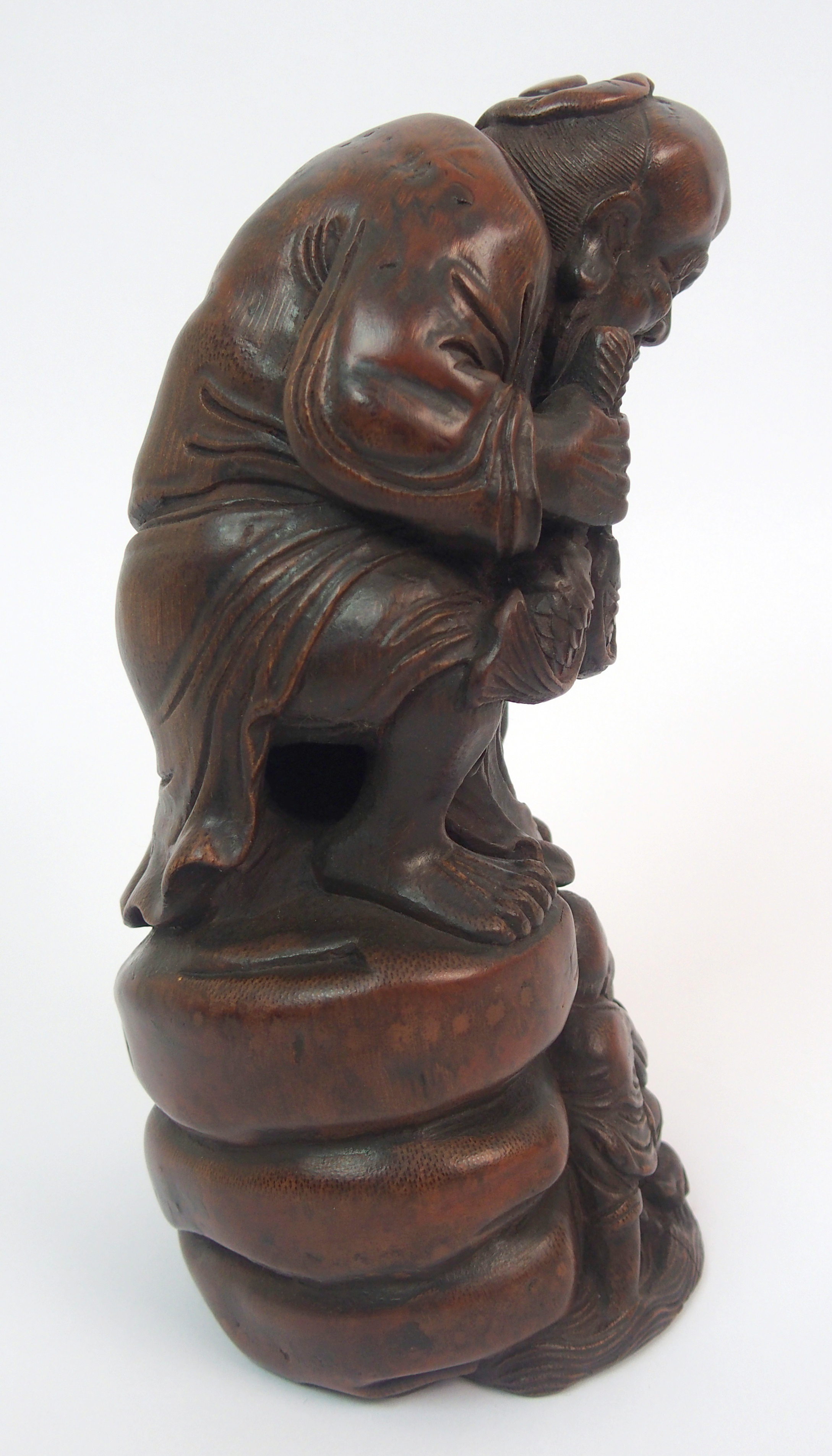 A Chinese bamboo figure of a fisherman seated on a rock above a young boy holding a fish amongst - Image 5 of 10