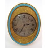 A gilded metal oval strut clock the silvered dial with chased scrolling acanthus decoration and