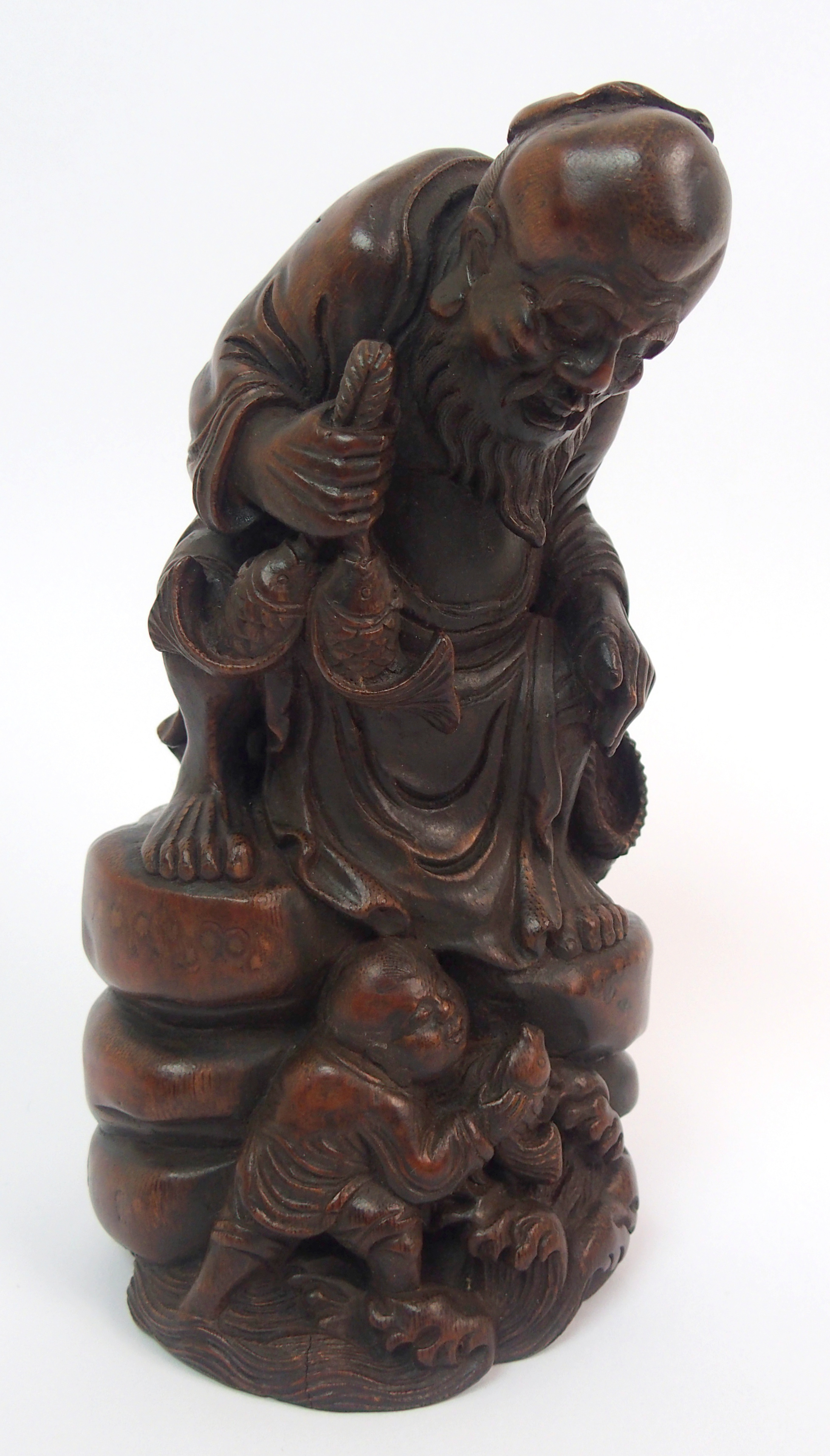 A Chinese bamboo figure of a fisherman seated on a rock above a young boy holding a fish amongst - Image 2 of 10