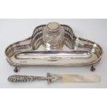 A silver inkstand by Martin Hall & Co, Sheffield 1901, of trefoil shape with pierced gallery, pen