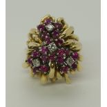 A bright yellow metal ruby and diamond retro cluster ring the rubies and diamonds are set as flowers